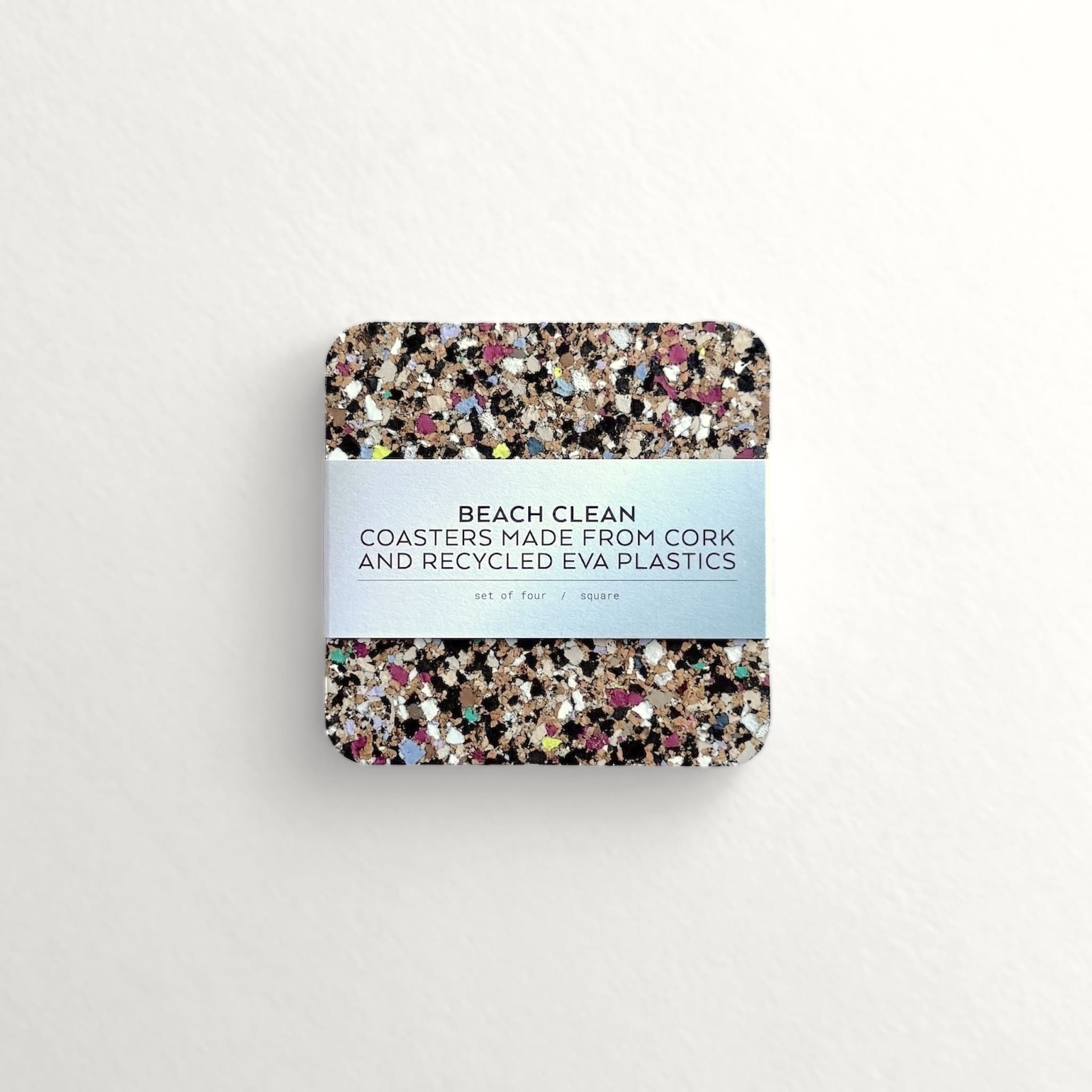 Pack of coasters made from cork and recycled EVA plastics on a light grey background