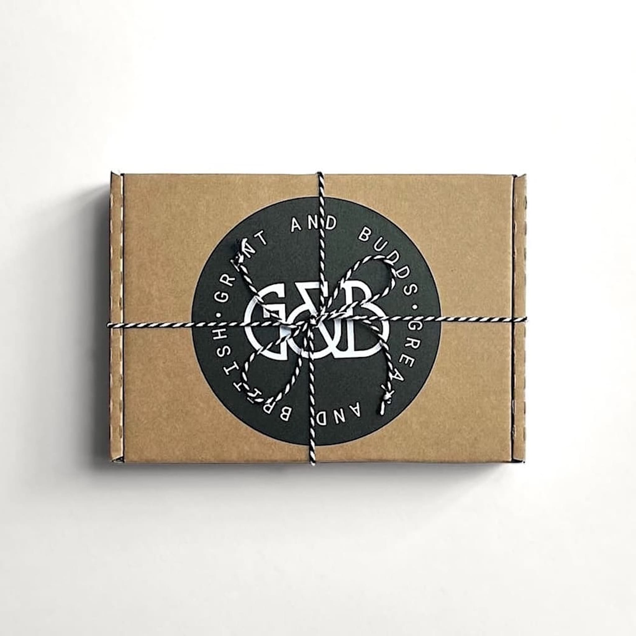 Grant and Budds gift box with a black circular label featuring white text on a white background