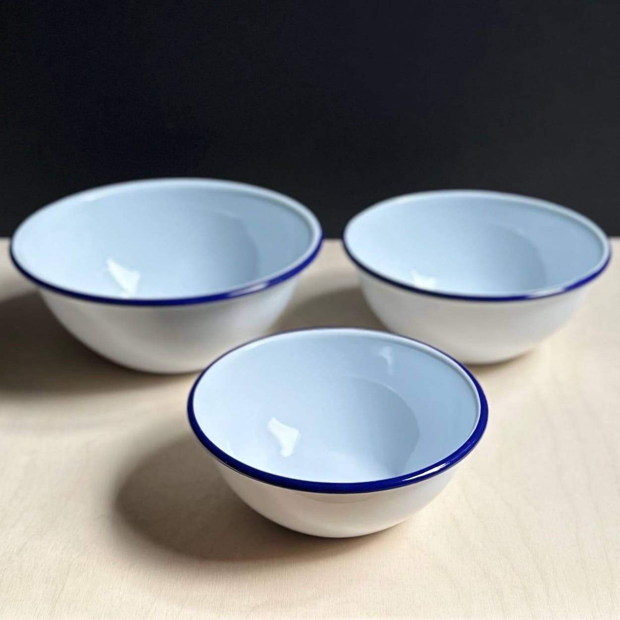 Trio of Blue Rimmed White Enamel Nesting Bowls
