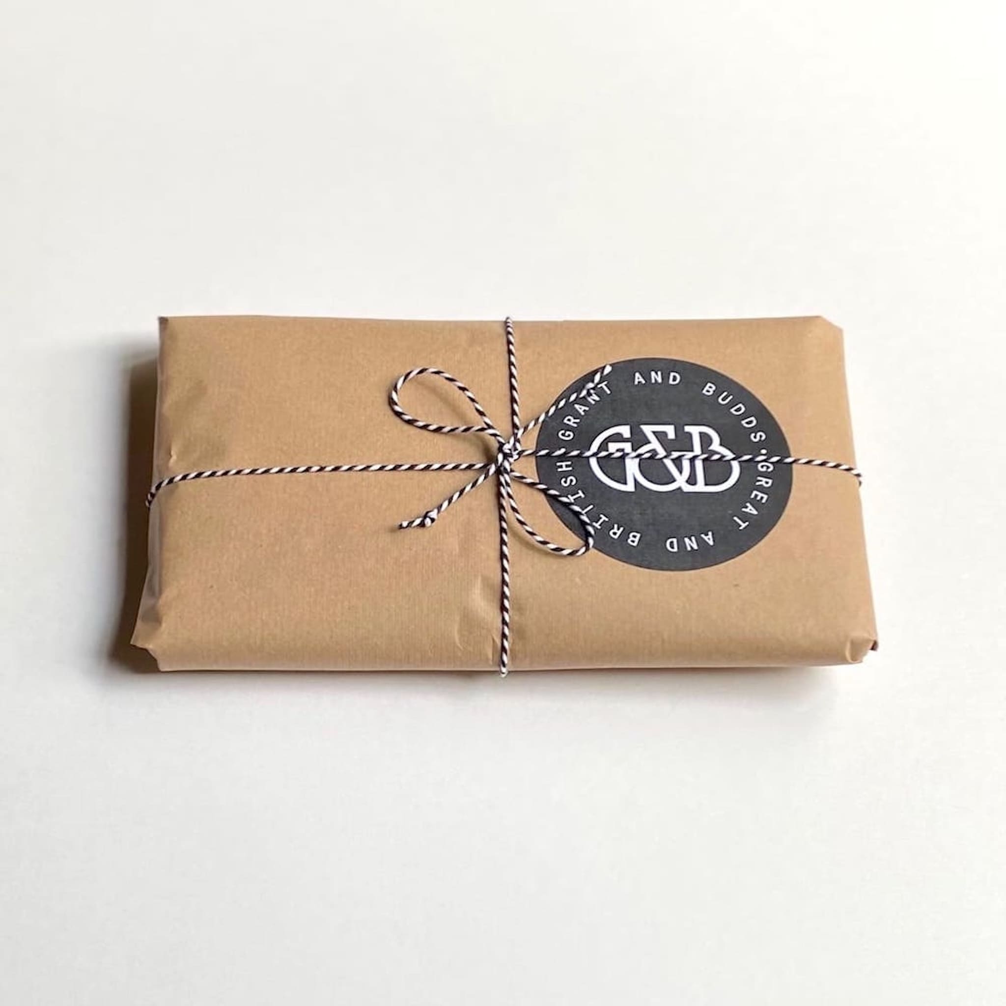 Grant and Budds branded brown paper gift wrapped parcel 