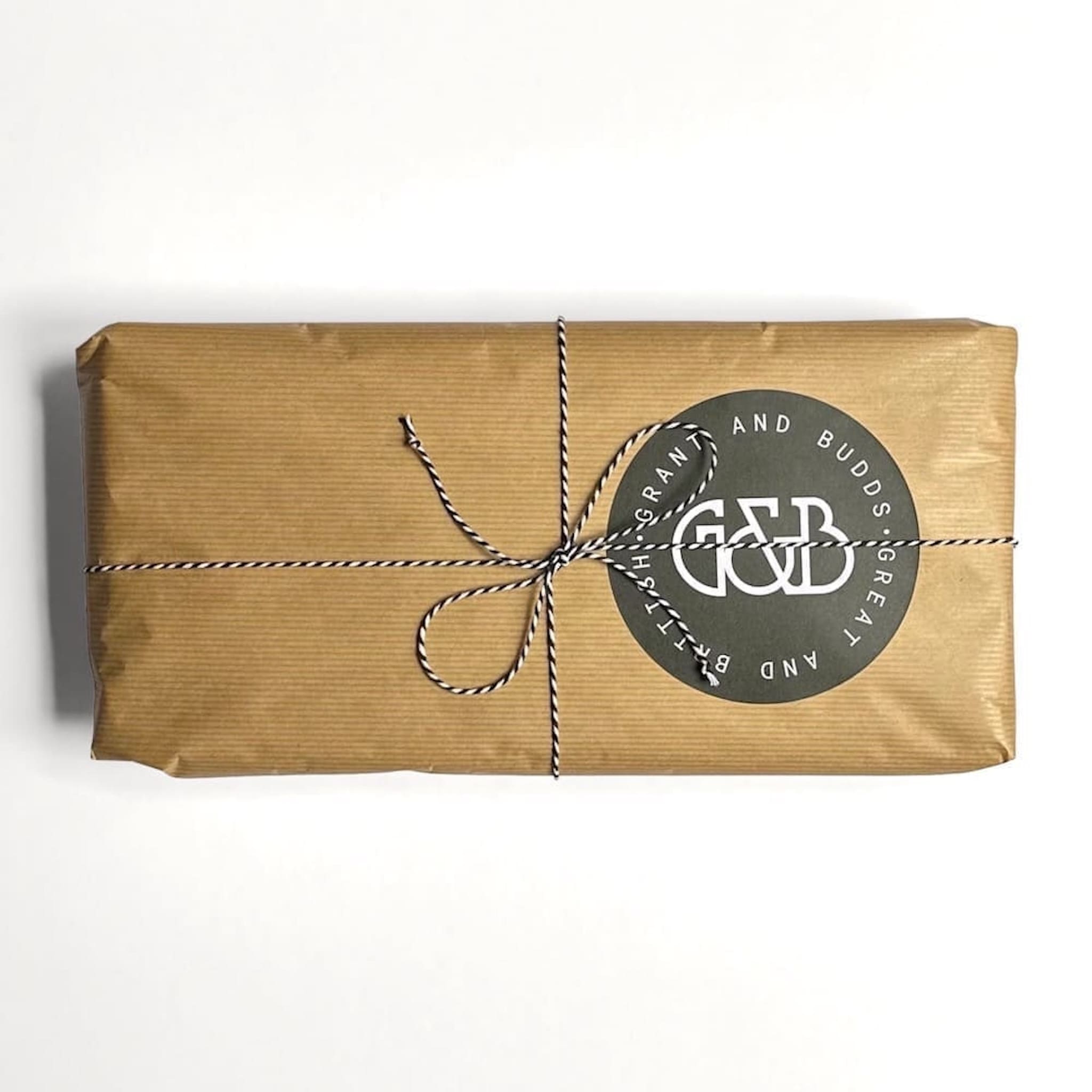Grant & Budds gift wrapped salad servers in brown paper with string and a label on a white background
